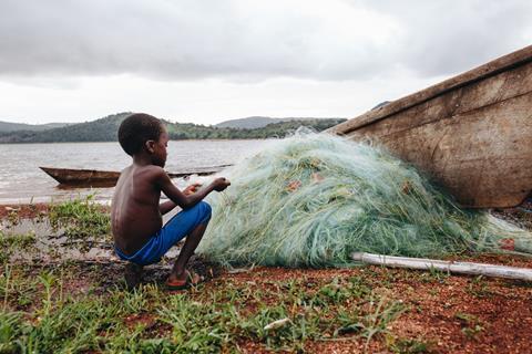 pp42-43_InFaith_Ghanaian Child Mending Net on Lake Volta ©IJM & Bri Rapp